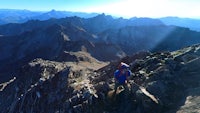 a person is standing on top of a rocky mountain